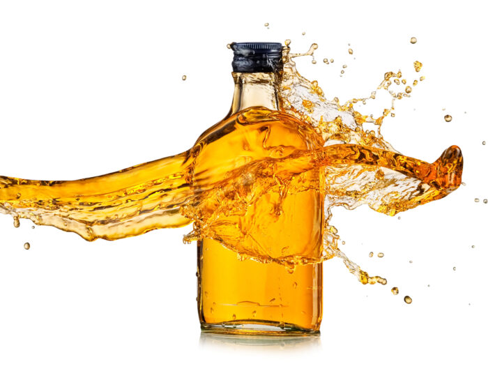 Small,Flat,Whiskey,Bottle,Splash,On,White,Background